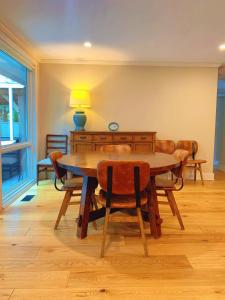 a dining room with a wooden table and chairs at Northern Stay in North Vancouver