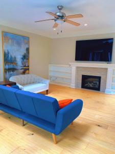 a living room with a blue couch and a fireplace at Northern Stay in North Vancouver