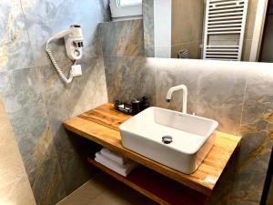 a bathroom with a sink and a phone on the wall at Lucas 10 Apartments in Cluj-Napoca +83 photos