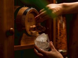 a person pouring a glass of wine from a wine barrel at HOTEL RELIEF Kokura Station in Kitakyushu +18 photos