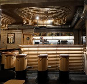 a restaurant with a bar with stools at Horský hotel Brans in Malá Morávka