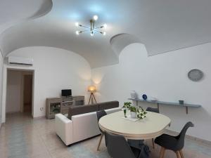 a living room with a table and a couch at Casa logudoro 7 in Sorso