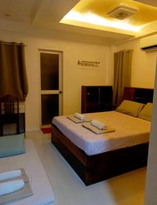 Ένα ή περισσότερα κρεβάτια σε δωμάτιο στο Panikseafarm Couple Room in a Homestay at San Juan La Union - Panikseafarm