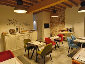 ein Restaurant mit Tischen und Stühlen und einer Küche in der Unterkunft 4 Elementi Relais B&B Lonato del Garda in Lonato