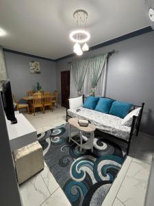 a living room with a bed and a dining room at Sunset Villa 786 Overport in Durban