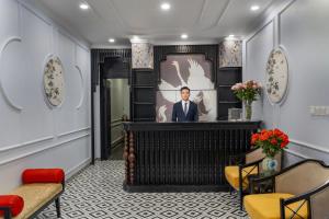 a lobby with a portrait of a man in a suit at Hanoi Royal Premium Hotel in Hanoi