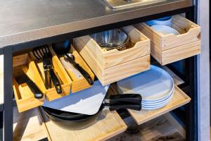a kitchen counter with wooden drawers and utensils at tomarutoko OGUSU in Fukuoka