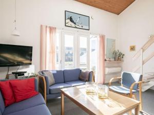 a living room with a blue couch and a table at 5 person holiday home in Vestervig in Vestervig