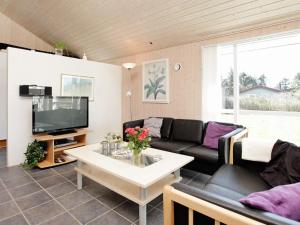 a living room with a couch and a table at Modern Beach Retreat - By Traum Ferienwohnungen in Trudslev