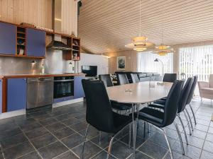 a kitchen with a dining room table and chairs at Modern Beach Retreat - By Traum Ferienwohnungen in Trudslev +19 photos