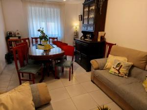 a living room with a couch and a dining room table at Casa Pita in San Justo de la Vega