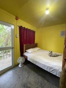 a bedroom with two beds and a window at Destiny Rainbow Beach Resort in Siquijor +81 photos