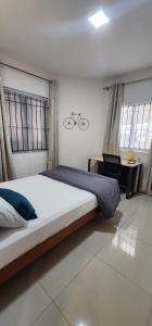 a bedroom with a large bed and a desk at Nayuha Beach New Penthouse B3 in Flic-en-Flac +32 photos