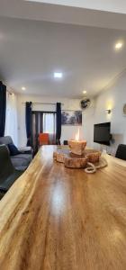 a living room with a large wooden table with a fire pit at Nayuha Beach New Penthouse B3 in Flic-en-Flac