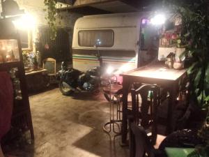 a motor bike parked in a garage with a caravan at GN GOOD NICE in Bangkok