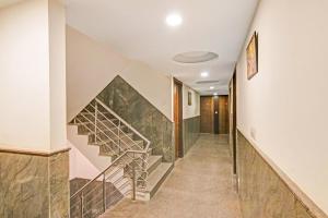 a hallway with a staircase in a house at Hotel O Avi Suites in New Delhi