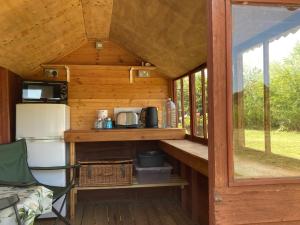 an inside view of a tiny house with a kitchen at Aberllynfi Riverside Guest House in Glasbury