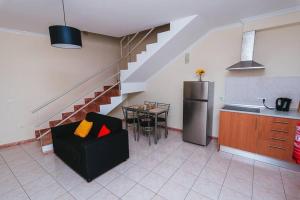 a kitchen with a couch and a table in a room at Cozy Private Apartment Calheta in Arco da Calheta