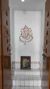 a painting on a wall in a bathroom at Casa de Familia - 2BHK - Homestay - Manyata Tech Park - Hebbal Kempapura in Bengaluru