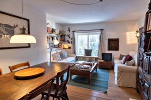 a living room with a table and a couch at Chesa Centrum 6pax - Celerina in Celerina
