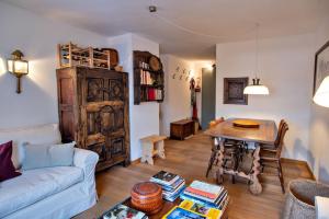 a living room with a table and a couch at Chesa Centrum 6pax - Celerina in Celerina