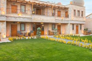 a large house with a lawn in front of it at Rapsodi Cappadocia in Göreme