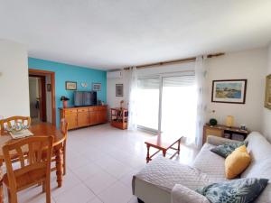 a living room with a couch and a table at Front beach apartment in Torreblanca