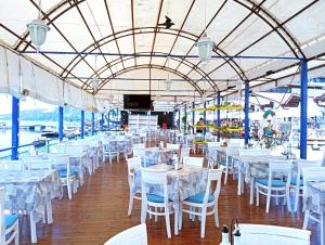a banquet hall with white tables and chairs at Lotos Hotel in Balchik