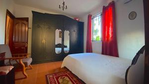 a bedroom with a bed and a black cabinet at 2 Bedroom Ground Floor Apartment 1 km from the Beach in Belle Mare