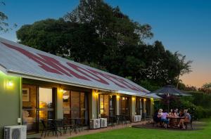 a group of people sitting at a table outside of a building at Maleny Views Motel in Maleny