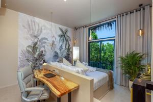 a bedroom with a bed and a desk and a window at Archie s Paradise View in Koh Phangan
