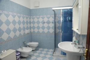 a bathroom with two toilets and a sink and a shower at Emerald House Shiroke in Shkodër +32 photos