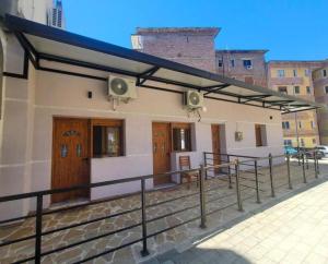 a building with awnings on the side of it at Cozy Apartments Permet in Përmet
