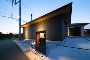 a building with a pay meter on the side of it at 海近1棟貸し,テラスでBBQ,85インチTVで映画三昧,早朝海散歩,大人が休める静かな隠れ家---HK House--- in Ichinomiya +35 photos