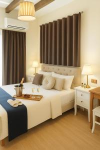 a bedroom with a large white bed with glasses of wine at Pantheon Luxury Suite Rome Historic Center in Rome