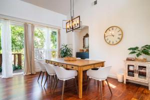 a dining room with a table and chairs and a clock at Folsom 4BR Retreat - Backyard & Parking in Folsom