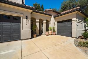 a house with two garage doors and a driveway at Folsom 4BR Retreat - Backyard & Parking in Folsom