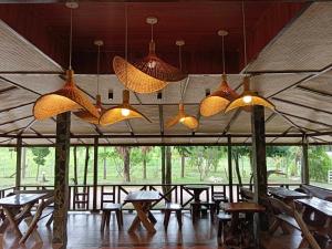 a group of lights hanging from the ceiling of a tent at Cozy Cottage by Chanita in Suan Phung