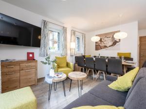 a living room with a couch and a table at Chalet Mühlbach near Hochkönig Ski Lift in Mühlbach am Hochkönig