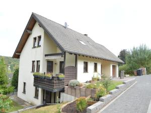 a white house with a black roof at Holiday Home Niederehe Romantic Escape in Niederehe