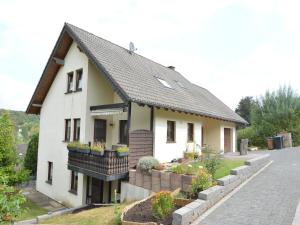 a white house with some plants in front of it at Holiday Home Niederehe Romantic Escape in Niederehe +24 photos