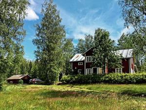 a red house in the middle of a field at Historic Charm in Varmland Oasis-By Traum in Östmark