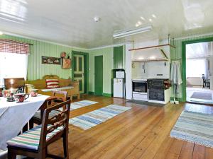 a large living room with green walls and wooden floors at 8 person holiday home in Östmark in Östmark