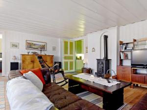 a living room with a couch and a table at 8 person holiday home in Östmark in Östmark +14 photos