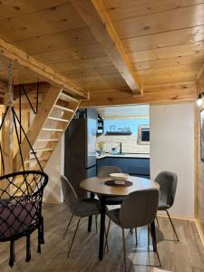 a kitchen and dining room with a table and chairs at HRID - vikendica u prirodi in Šavnik