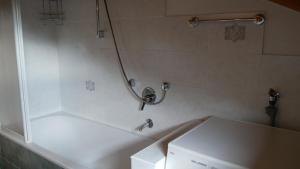 a bathroom with a white tub and a sink at Enzian in Sesto +14 photos