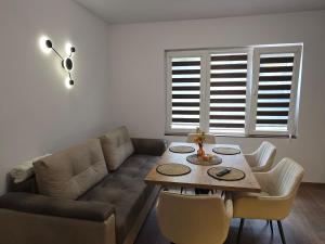 a living room with a couch and a table at Апартамент Дар in Belogradchik +19 photos