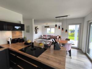 a kitchen and living room with a large counter top at VILLA VULKANEIFEL -modern -familienfreundlich -Terrasse -Doppelgarage -ruhiger Lage in Darscheid +38 photos