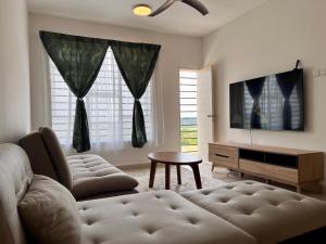 a living room with a couch and a table at Sireh Family Homestay in Kota Bharu