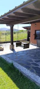 a pavilion with a table and a swing at Casa Penelas in Petín